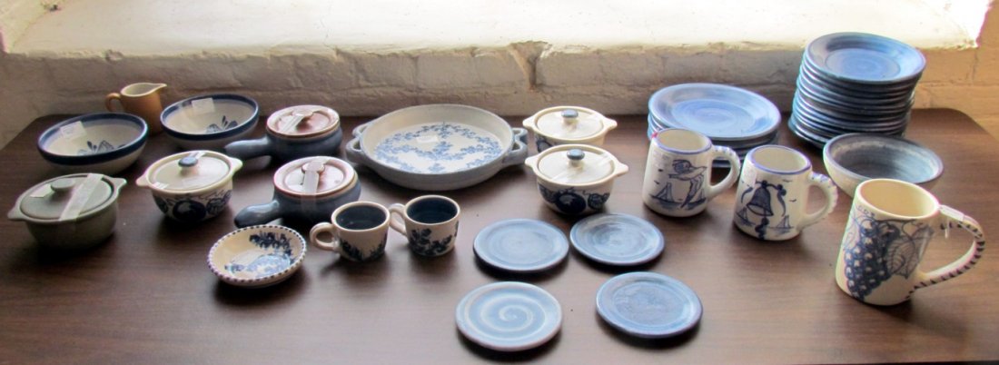 Approx. 42 Pieces of Dorchester Pottery Assorted Patter: Blueberry pattern: three covered casseroles, two demitasse, and serving plate. Strawberry pattern: two bowl. Blue: two covered casseroles, Five 7.5 in. plates, 13 6.5 in., four, and four saucers, and