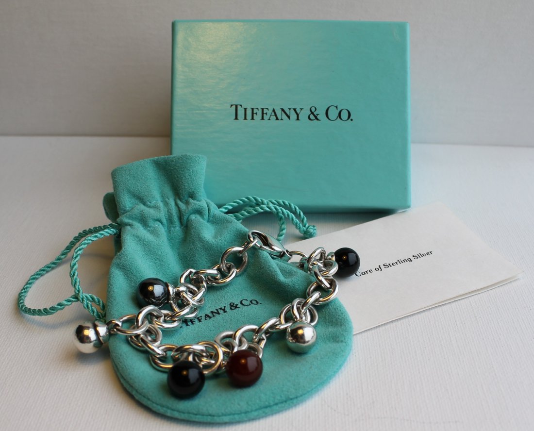Rare Tiffany Fascination Sterling Onyx Bracelet New in : Tiffany heavy Sterling bracelet with 6 round ball charms....2 sterling, 2 onyx, 1 hematite and 1 carnelian. Measures 7.5in h. weighs 1.5 oz. Comes with original, tissue, box and pouch