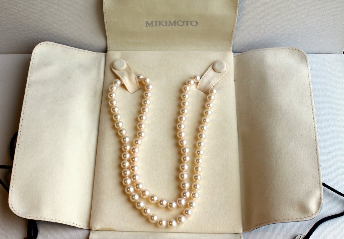 22" Strand of Mikimoto Blue Cultivated Pearl Necklace: 22" string of cultivated Blue Lagoon Mikimoto pearls. Size approx. 7x7 1/2 mm Beautiful luster. 14YG clasp. Comes with bag and box.