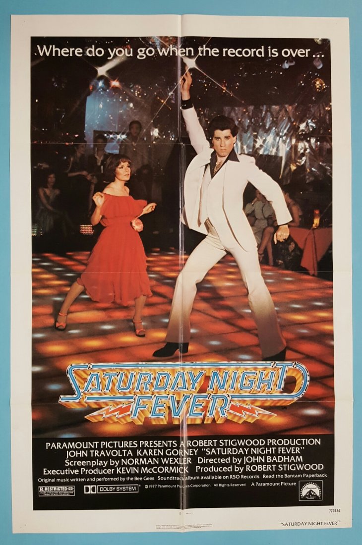 Saturday Night Fever 1977 One Sheet Movie Poster: (Paramount) Starring John Travolta and Karen Gorney. This is an unrestored folded poster with minor fold wear and a small separation at the cross fold. The poster was displayed by a staple in each cor