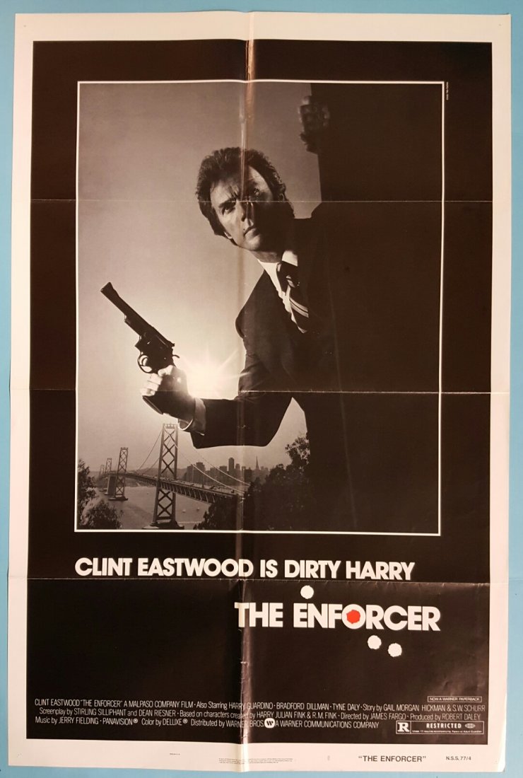 The Enforcer 1977 One Sheet Movie Poster: (Warner Bros.) Starring Clint Eastwood. This is a folded unrestored poster in very presentable condition with fold wear, pinholes, and minor staining at the bottom along the fold.