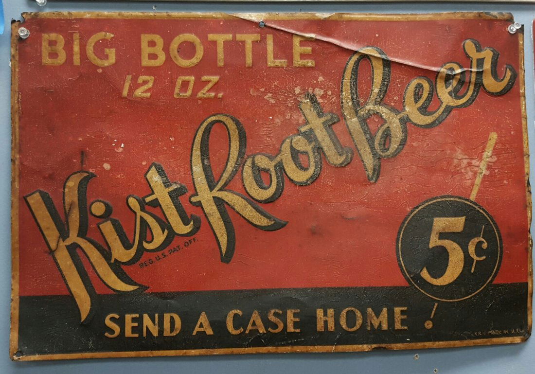Kist Root Beer Early Tin Advertising Sign: Vintage 19.5" x 13 embossed Kist Root Beer sign. An original sign in overall good condition with signs of used including scuffs, scratches, and a crease along the top of the sign.