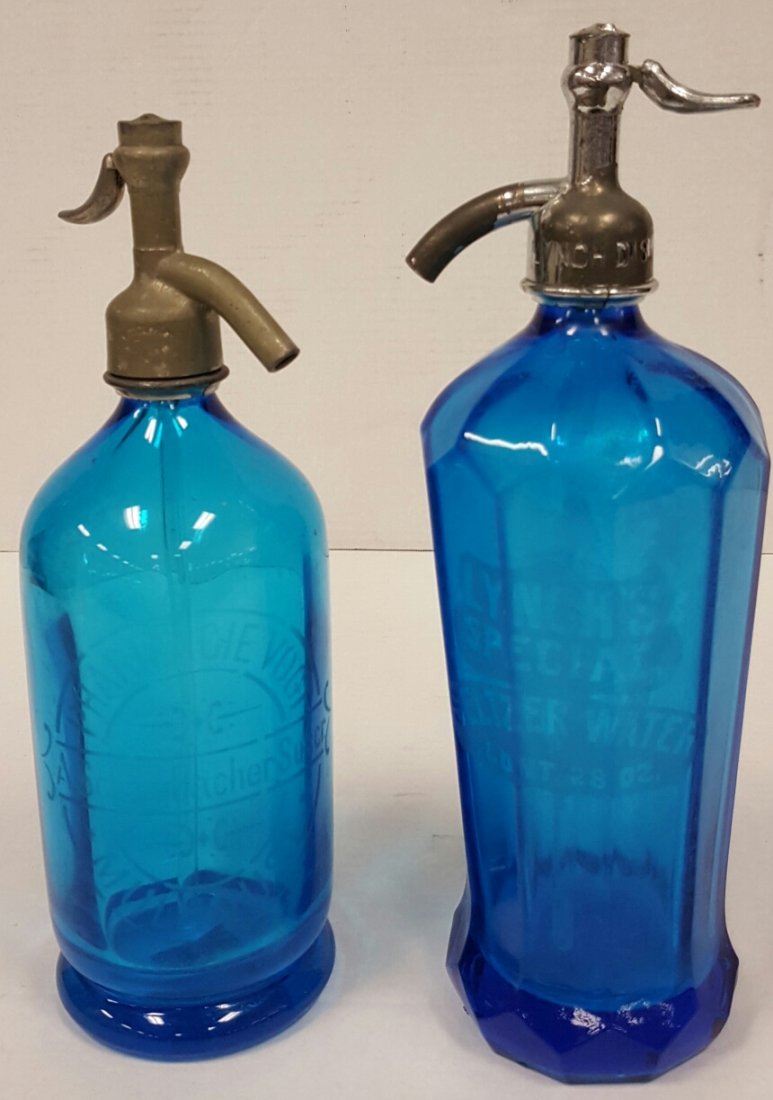2 Blue Seltzer Bottles Lynch's Special & Pharmacie: Both bottles are in excellent condition with minor scuffs. Both dispensing tops appear to be complete with the glass siphon tubes. One bottle is etched Lynch's Special Seltzer Water Cont. 28oz. the ot