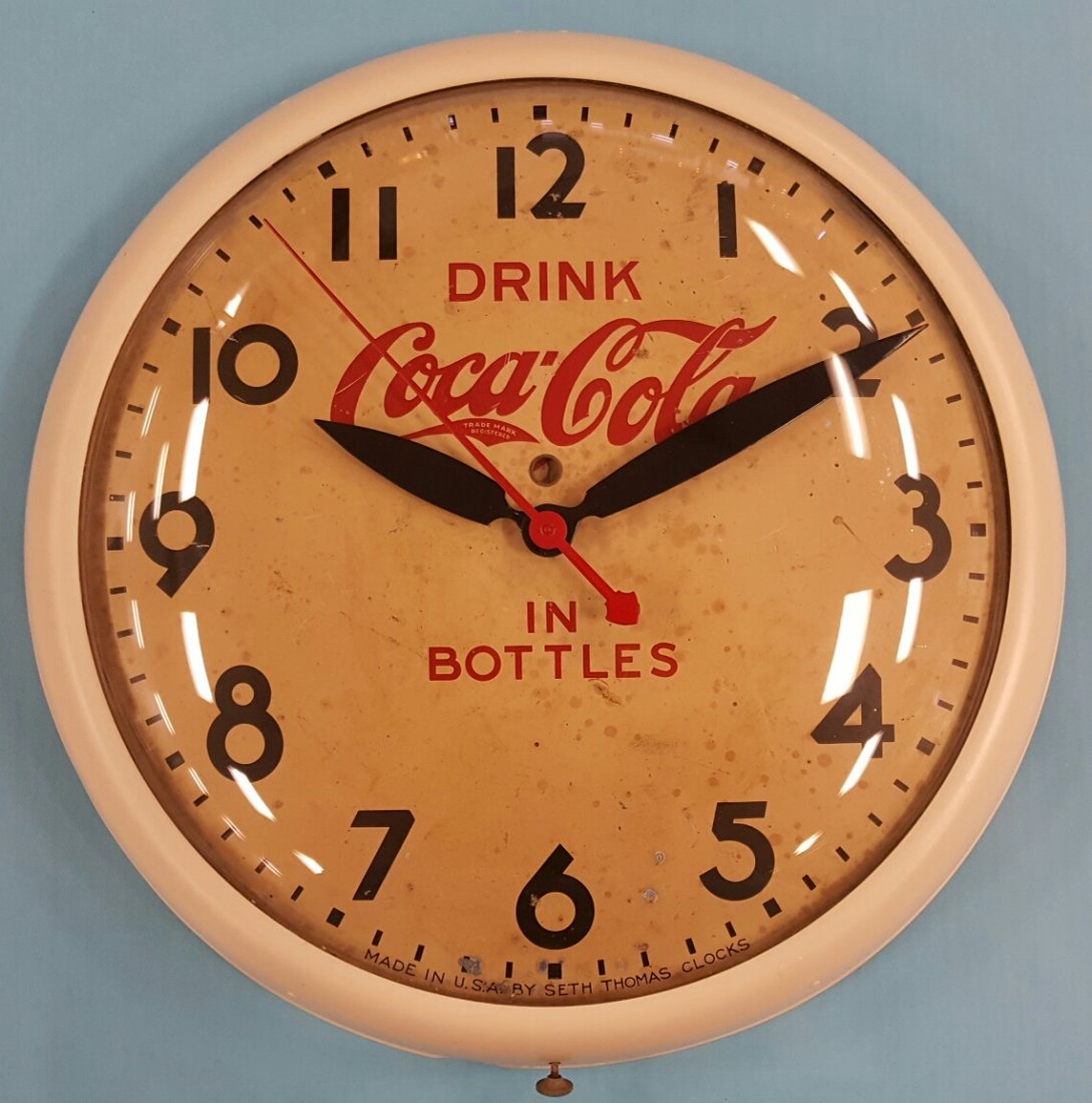 1930's Coca Cola Seth Thomas Clock: A 1930's classic Coca Cola electric clock working. The metal frame has been repainted and the clock face shows minor spotting and scuffs.