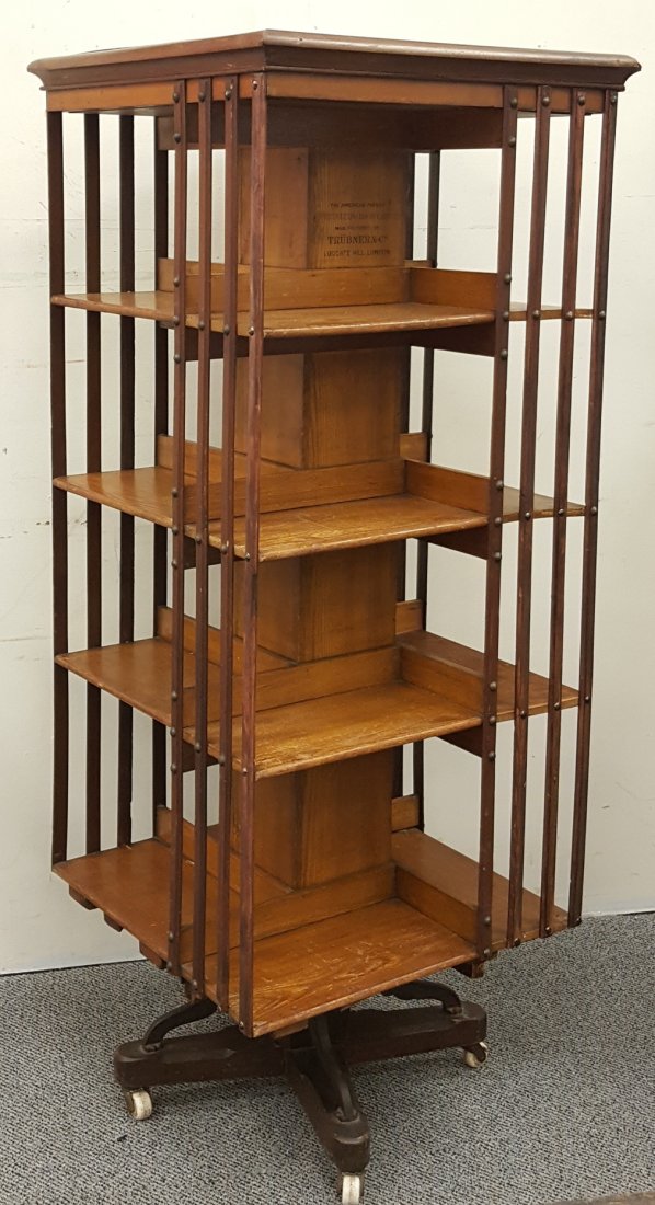 An Edwardian Revolving Bookcase Trubner & Co.: An early 20th century four shelf revolving bookcase stamped THE AMERICAN PATENT REVOLVING BOOKCASE, MANUFACTURED BY TRUBNER & CO. LUDGATE HILL, LONDON. 11.5" X 11.5" X 58.5". Please read and understan