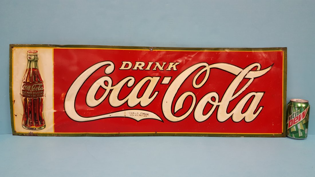 1931 Drink Coca Cola Embossed Tin Sign w/ Bottle: 35" x 11.5" Original embossed tin sign with the 1923 Christmas bottle. The sign shows scuffs, scratches, and some fading. PLEASE READ & UNDERSTAND THE PAYMENT & SHIPPING TERMS FOR THIS AUCTION PRIOR T