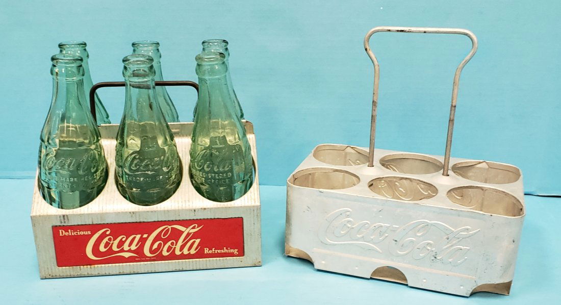 2 Coca Cola Aluminum 6 pack Carriers: 2 Original carriers one is embossed and both are in overall good condition. The lot includes 6 bottles. PLEASE READ & UNDERSTAND THE PAYMENT & SHIPPING TERMS FOR THIS AUCTION PRIOR TO PLACING BIDS.