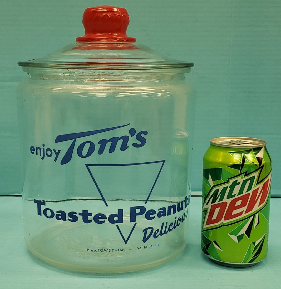 Tom's Toasted Peanuts Jar with Lid: 10" Tall jar with embossed lid and blue graphics. There is a 2" chip in the rim otherwise the jar is in excellent condition. PLEASE READ & UNDERSTAND THE PAYMENT & SHIPPING TERMS FOR THIS AUCTION PRIO