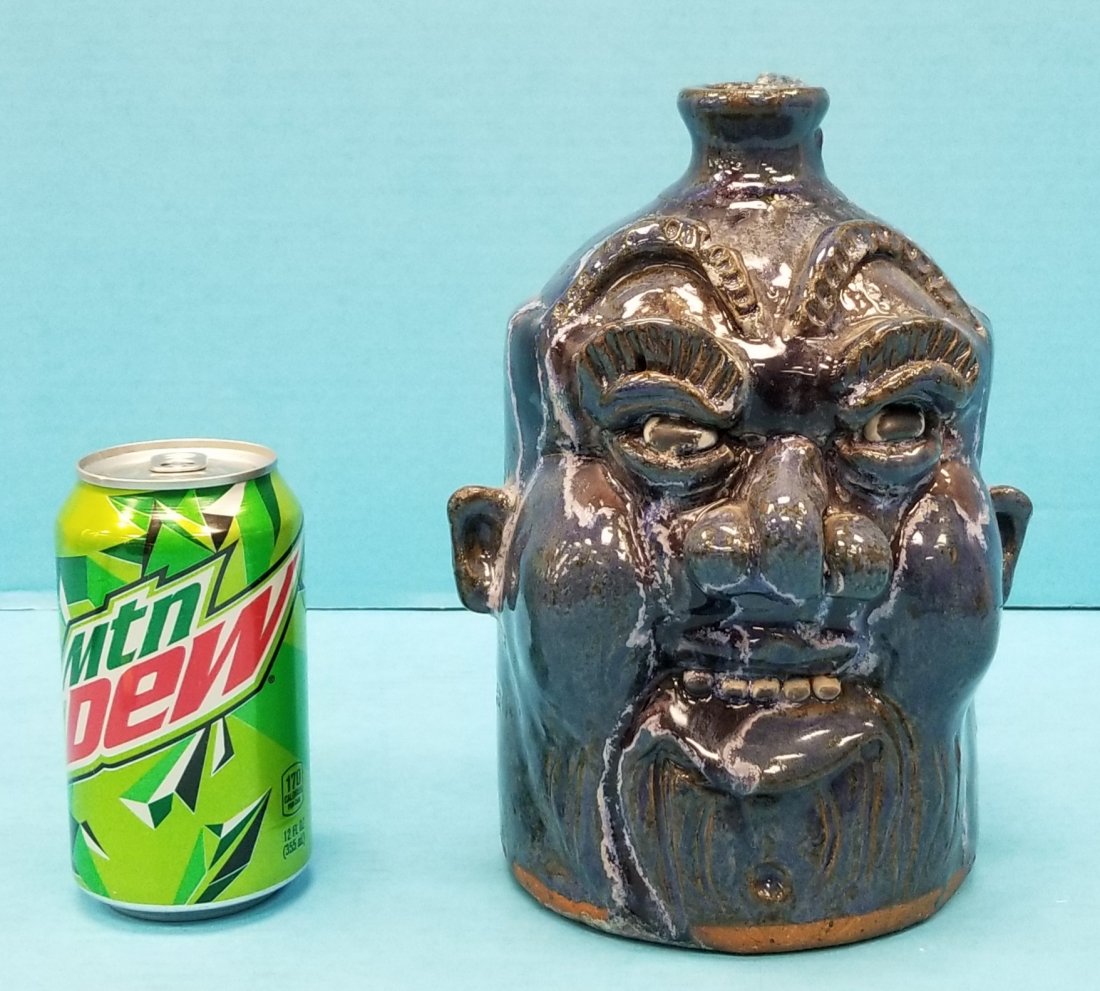 Clete Meaders Face Jug: 8.75"h face jug with poem on the back that reads: I am strong because I have been weak I am fearless because I have been afraid I am wise because I have been foolish. Signed and dated Mar. 1 2012 on t