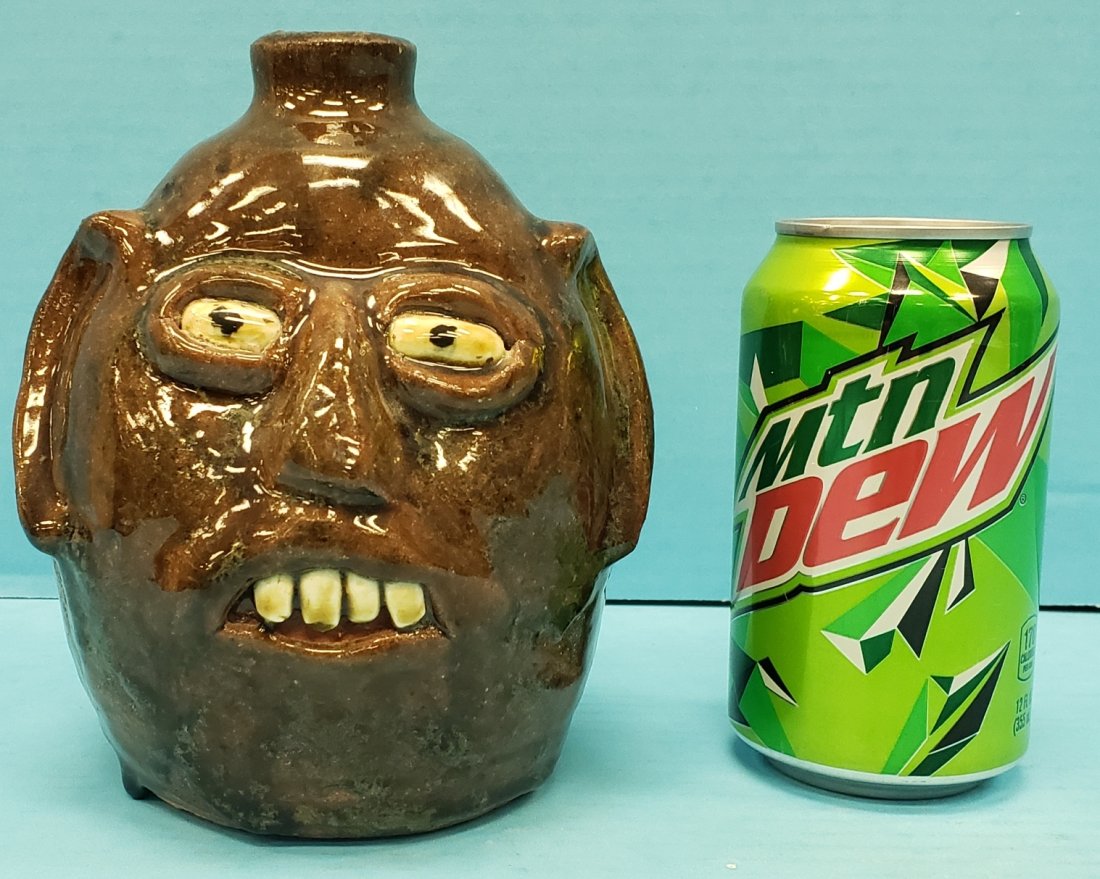 Reggie Meaders Face Jug: 6.5" Glazed face jug with four teeth. Signed and in excellent condition. PLEASE READ & UNDERSTAND THE PAYMENT & SHIPPING TERMS FOR THIS AUCTION PRIOR TO PLACING BIDS.