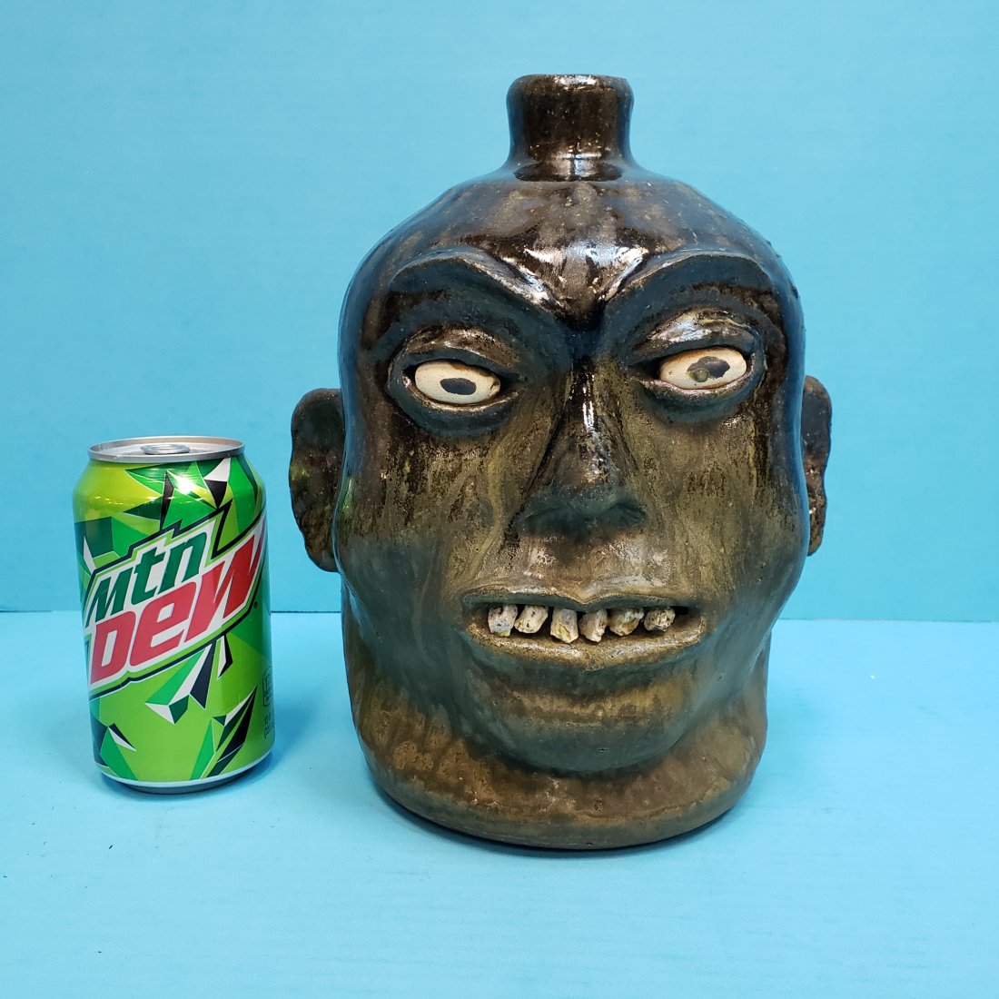 Lanier Meaders Rock Tooth Face Jug: 9.5" Glazed face jug with 6 rock teeth in excellent condition. Signed Lanier Meaders on the bottom. PLEASE READ & UNDERSTAND THE PAYMENT & SHIPPING TERMS FOR THIS AUCTION PRIOR TO PLACING BIDS.