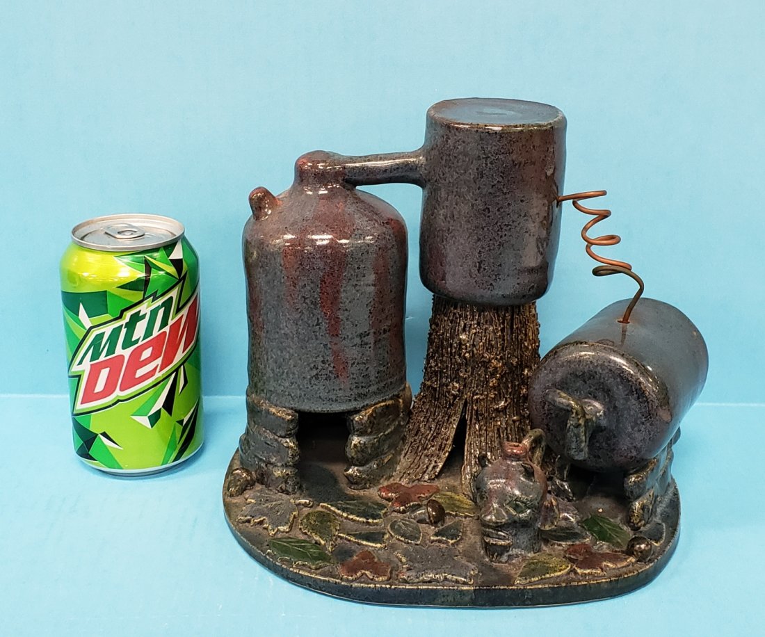 Lin Craven Moonshine Scene Southern Folk Pottery: 7.5" 2000 Detailed moonshine still with mini devil jug and multi colored foliage in excellent condition. Signed and dated on the bottom. PLEASE READ & UNDERSTAND THE PAYMENT & SHIPPING TERMS FOR THIS 