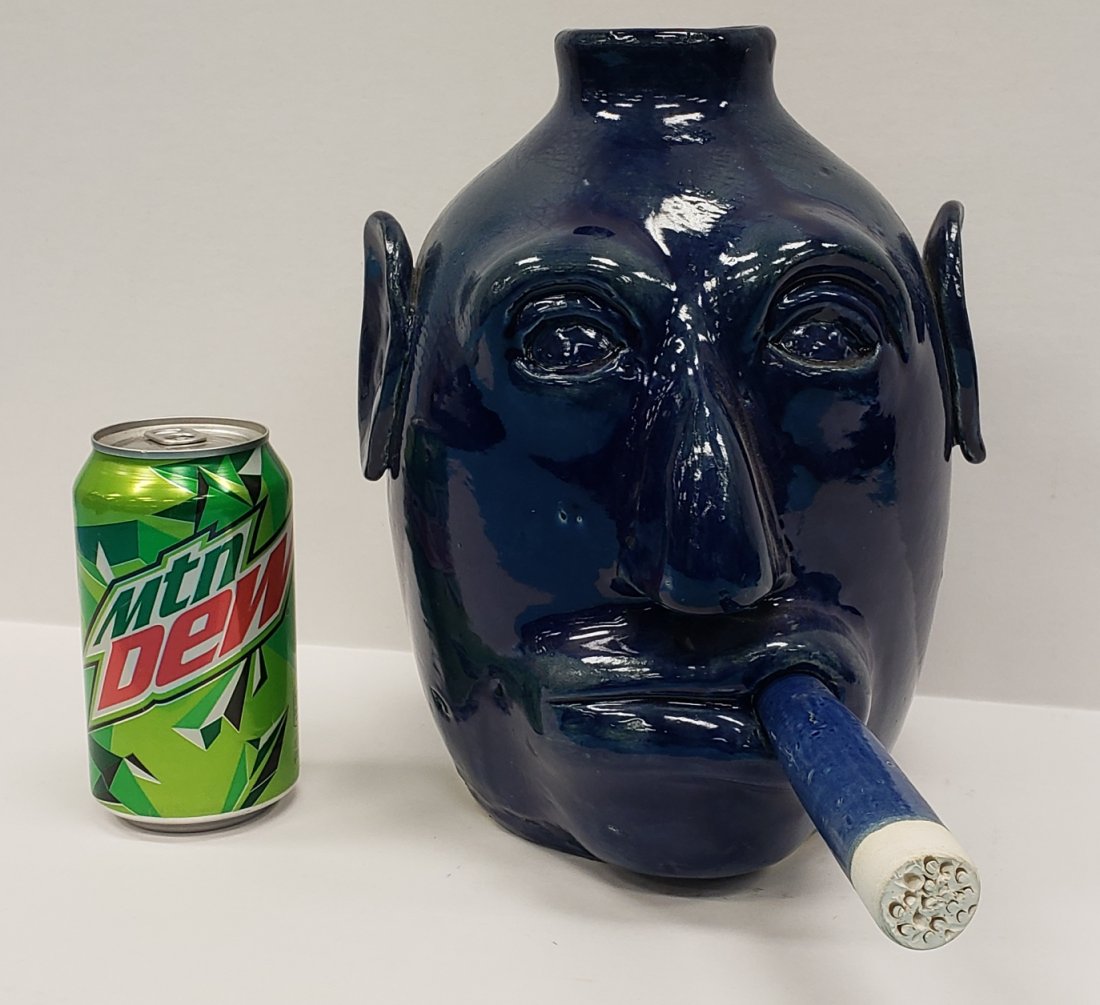Edwin Meaders Blue Face Jug with Cigar: 10" Blue face jug with cigar sticking out of the mouth in excellent condition. signed Edwin Meaders 1-15-2011. PLEASE READ & UNDERSTAND THE PAYMENT & SHIPPING TERMS FOR THIS AUCTION PRIOR TO PLACING B