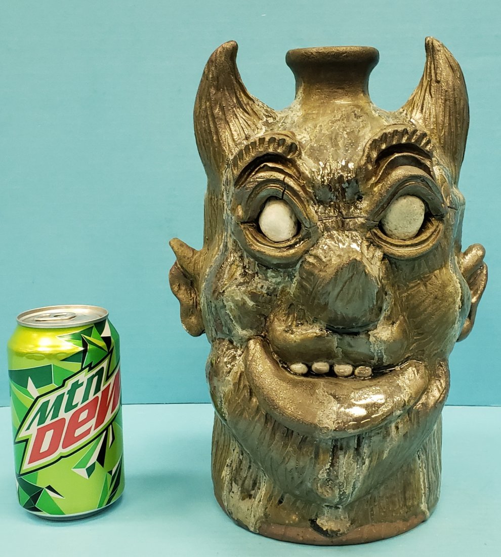 Clete Meaders Rock Eyed Sam Face Jug: 11.25"h Glazed face jug with small crack on one eye brow. Inscribed Rock Eyed Sam on the back, signed and dated 2011 on the bottom. PLEASE READ & UNDERSTAND THE PAYMENT & SHIPPING TERMS FOR THIS AUCTI