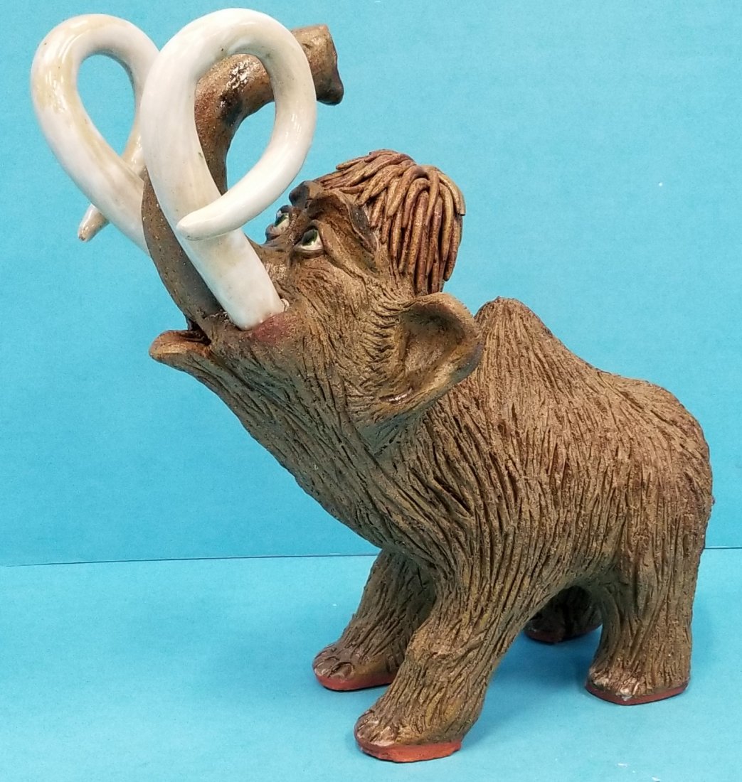 Rex Hogan Woolly Mammoth Pottery: 11.5l x 12.5h. Two small pieces missing on top of head and a small repair. See pictures. Signed Rex Hogan 2013 on the backside. PLEASE READ & UNDERSTAND THE PAYMENT & SHIPPING TERMS FOR THIS AUCTION P