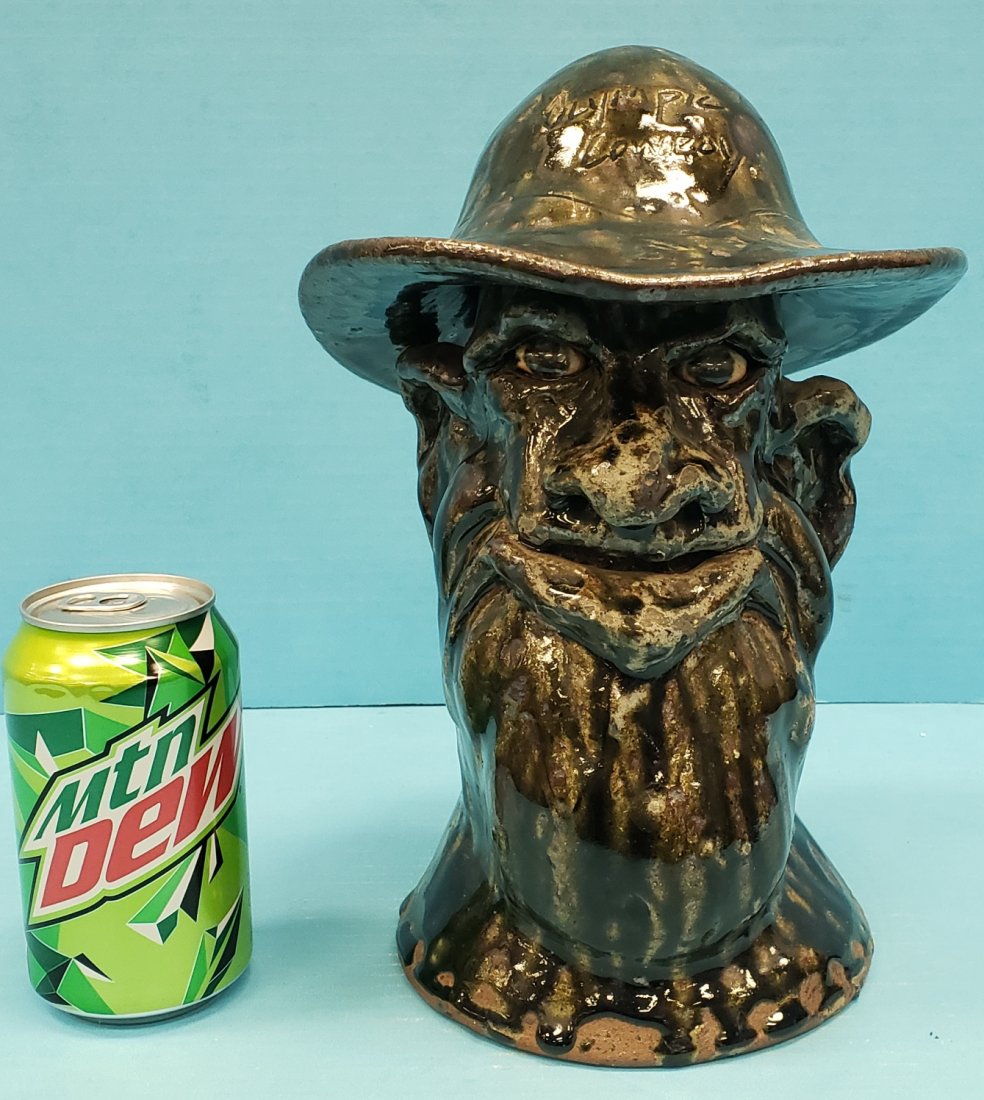 Clete Meaders Face Jug/Bust Olympic Cowboy: 11"h Glades bust with Olympic Cowboy inscribed on the front of the hat and Atlanta 1996 on the back of the hat. Signed and dated on the back. PLEASE READ & UNDERSTAND THE PAYMENT & SHIPPING TERMS FOR 