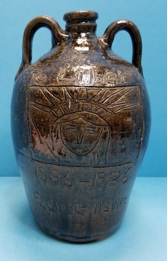 Chester Hewell To Liberty Double Handle Jug: 12"h Glazed jug with To Libery 1886-1986 From Gillsville on the front and Stars and Stripes Forever. Excellent condition. PLEASE READ & UNDERSTAND THE PAYMENT & SHIPPING TERMS FOR THIS AUCTION PRIOR T