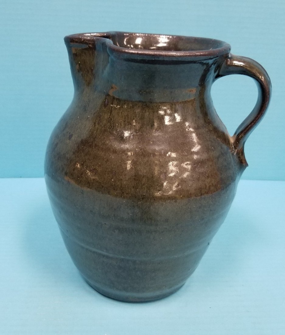 Nathaniel Hewell Pitcher folk art pottery: 9" glazed pitcher signed and dated 2000 on the bottom. PLEASE READ AND UNDERSTAND THE PAYMENT AND SHIPPING TERMS FOR THIS AUCTION PRIOR TO PLACING BIDS. ALL BIDDERS ARE BOUND TO THE TERMS OF THIS AUCT