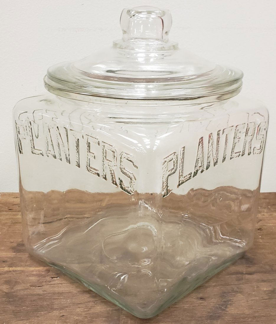 Planters Peanut Jar: 10" Glass jar and lid embossed Planters on all four sides. Excellent condition with a small chip in the rim of the lid. PLEASE READ AND UNDERSTAND THE PAYMENT AND SHIPPING TERMS FOR THIS AUCTION PRIOR