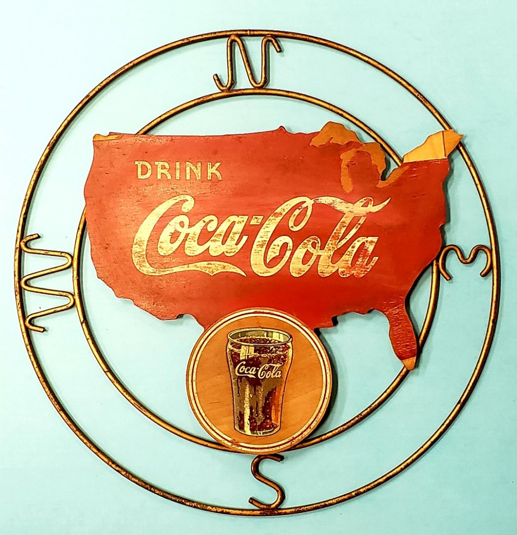 Drink Coca Cola Kay Displays Compass Sign: Scarce Kay Displays Coca Cola sign with wood and metal frame. The sign shows scuffs, scratches, and missing small pieces of wood on the corners. Stamped Kay Displays on the back. Hard to find sign. PL