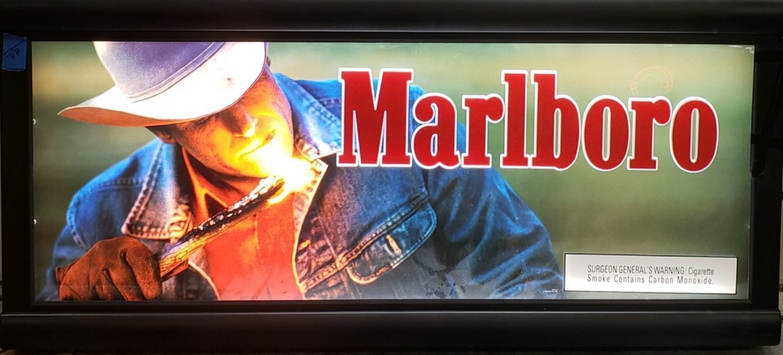 Marlboro Light Up Sign: 48" x 23" Light up sign in plastic frame with a crack in the plastic on the right side. PLEASE READ & UNDERSTAND THE PAYMENT & SHIPPING TERMS FOR THIS AUCTION PRIOR TO PLACING BIDS. ALL BIDDERS ARE BO