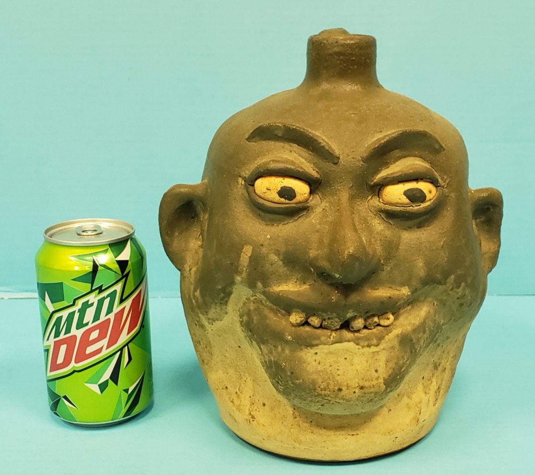 Lanier Meaders Matte Rock Tooth Face Jug: 9.5" Matte Army green glaze with rock teeth. Signed Lanier Meaders on the bottom. PLEASE READ & UNDERSTAND THE PAYMENT & SHIPPING TERMS FOR THIS AUCTION PRIOR TO PLACING BIDS. ALL BIDDERS ARE BOUND TO
