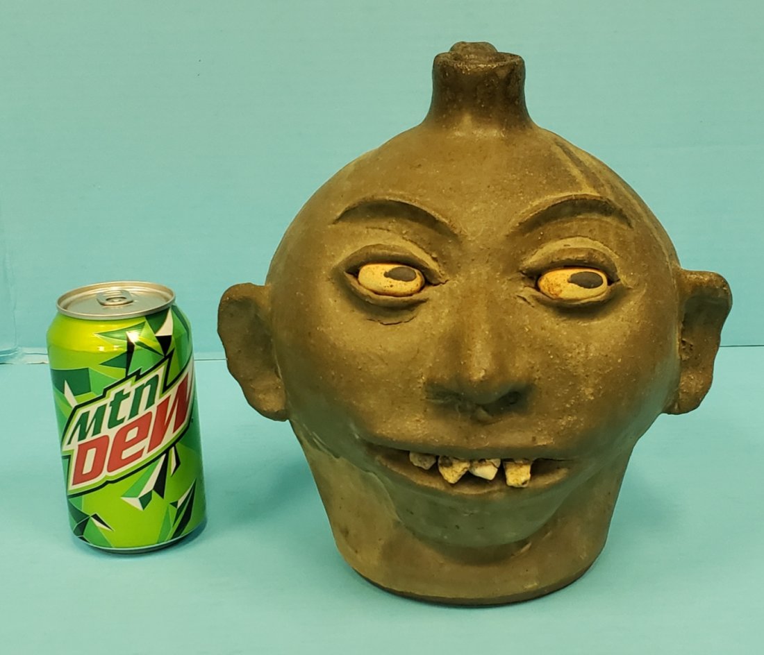 Lanier Meaders Matte Rock Tooth Face Jug: 9" Matte Army green glaze with rock teeth. Two small chips on the spout. Signed Lanier Meaders on the bottom. PLEASE READ & UNDERSTAND THE PAYMENT & SHIPPING TERMS FOR THIS AUCTION PRIOR TO PLACING BI