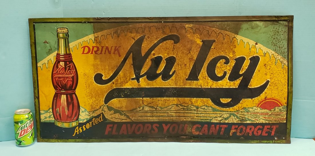 Drink Nu Icy Embossed Tin Sign: 36" x 17.75" Tin sign with scuffs, scratches, rust, small holes, and stains. PLEASE READ & UNDERSTAND THE PAYMENT & SHIPPING TERMS FOR THIS AUCTION PRIOR TO BIDS. ALL BIDDERS ARE BOUND TO THE TERMS OF