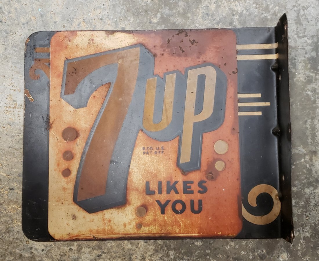 7up Likes You Flange Sign: 12" x 10" flange sign with scuffs, scratches, stains, & paint loss. by Stout Sign Company. PLEASE READ & UNDERSTAND THE PAYMENTS & SHIPPING TERMS FOR THIS AUCTION PRIOR TO PLACING BIDS. ALL BIDDERS AR
