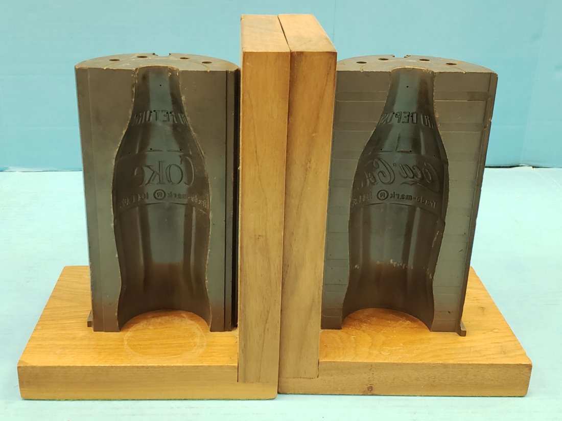 Coca Cola Bottle Mold Bookends: 5.25" x 6.5" x 9" Both halves of iron bottle molds mounted to wood for bookends. Excellent condition. PLEASE READ & UNDERSTAND THE PAYMENT & SHIPPING TERMS FOR THIS AUCTION PRIOR TO PLACING BIDS. ALL