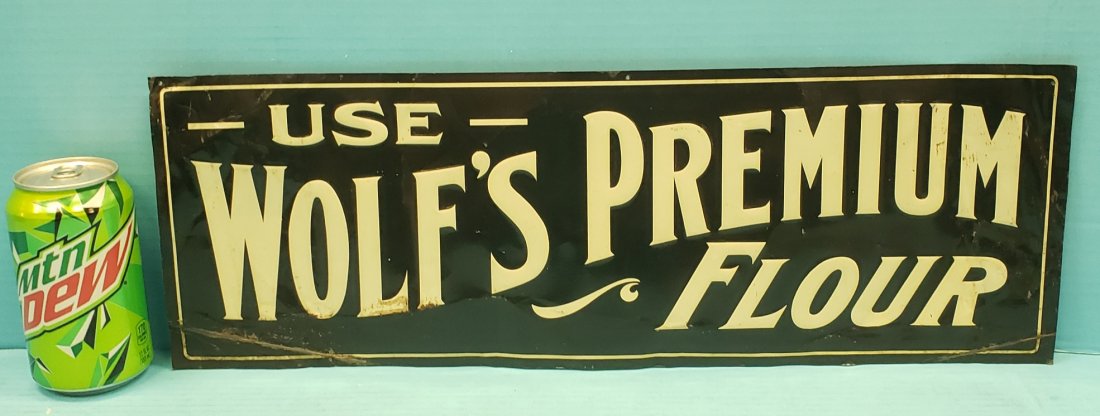 Wolf's Premium Flour Tin Sign: 19.75" x 7" tin sign with bright colors, bends, and scuffs. PLEASE READ & UNDERSTAND THE PAYMENT & SHIPPING TERMS FOR THIS AUCTION PRIOR TO PLACING BIDS. ALL BIDDERS ARE BOUND TO THE TERMS OF THIS AUC
