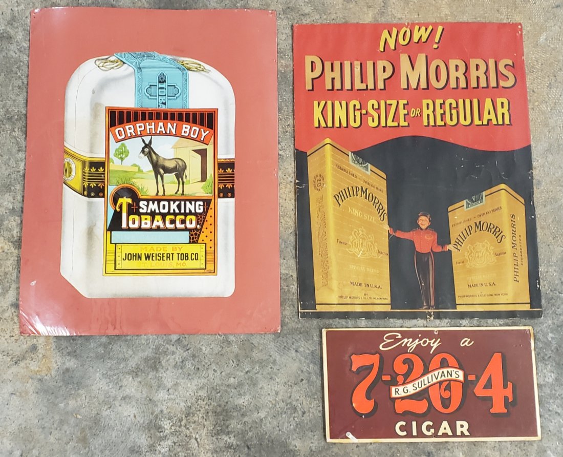 Lot of 3 Tobacco Signs: Lot of three signs including 19.5" x 25.5" orphan boy cardboard sign with pinholes, stains & edge wear. 18" x 23.5" Philip Morris cigarettes heavy stock paper sign with pinholes, bends, and small tear