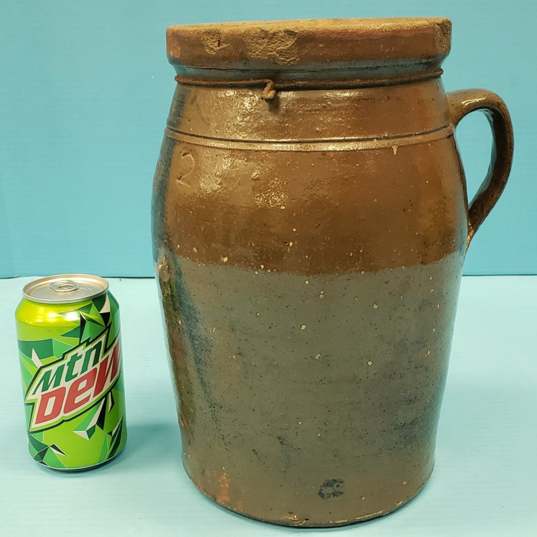 Earl Stork 2 gal churn Ca 1920's: 11" glazed churn with repaired handle and some chipping around the rim. Stamped Earl Stork Orange Co. Ga. PLEASE READ & UNDERSTAND THE PAYMENT AND SHIPPING TERMS FOR THIS AUCTION PRIOR TO PLACING BIDS