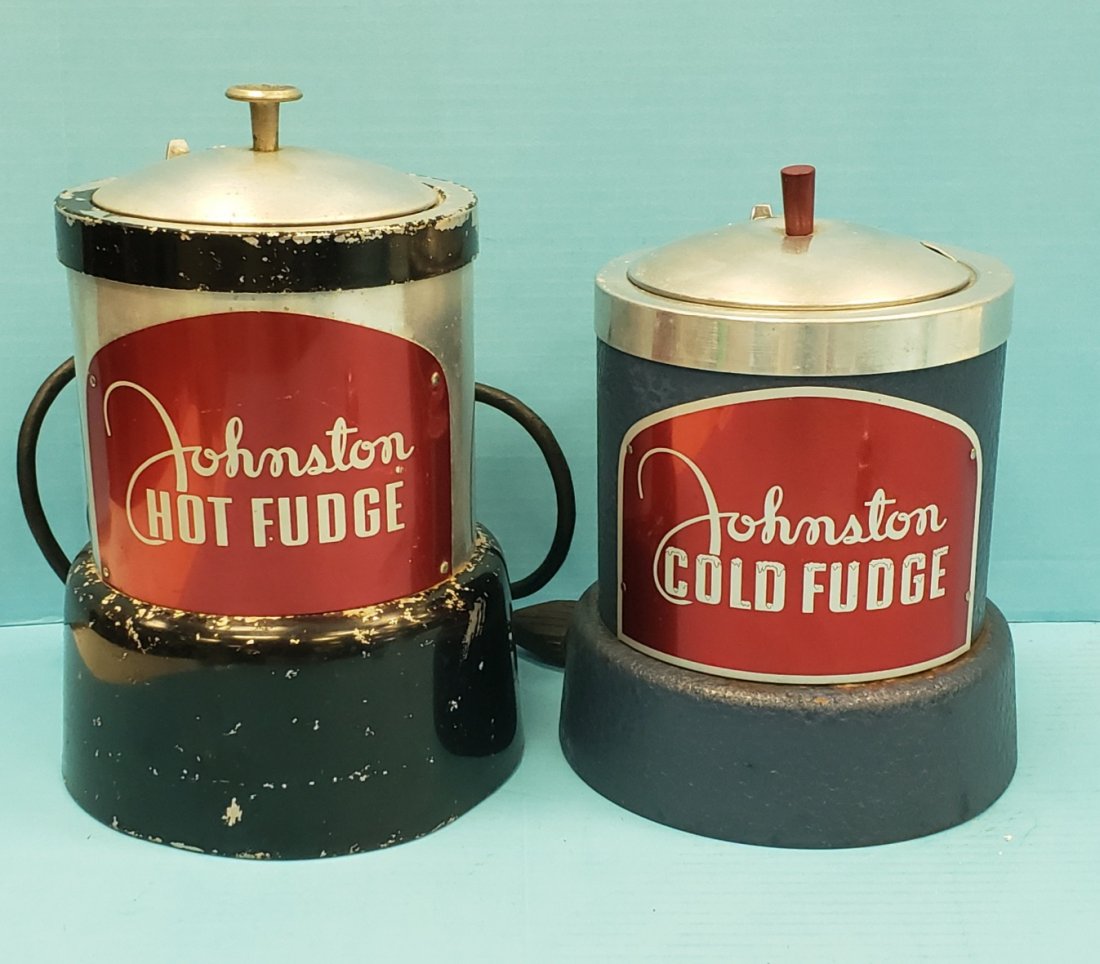 Johnston Hot & Cold Fudge Soda Fountain Dispensers: 10"h x 7"w Working Hot fudge dispenser with paint flakes and a 9"h x 7"w Metal Cold Fudge dispenser with aluminum top and bakelite handle, and metal Johnston Cold Fudge sign on front. Light wear with 