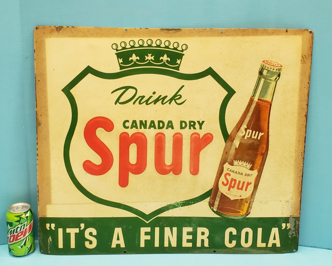 Spur Embossed Tin Sign: 26" x 22.5" Embossed sign with stains, light fading, paint flakes and scuffs. PLEASE READ & UNDERSTAND THE PAYMENT & SHIPPING TERMS FOR THIS AUCTION PRIOR TO PLACING BIDS. ALL BIDDERS ARE BOUND TO THE