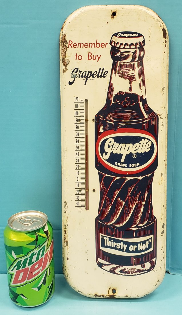 Grapette Thermometer: 5.75" x 16" Tin thermometer with scuffs, scratches, and minor paint flakes. PLEASE READ & UNDERSTAND THE PAYMENT & SHIPPING TERMS FOR THIS AUCTION PRIOR TO PLACING BIDS. ALL BIDDERS ARE BOUND TO THE T
