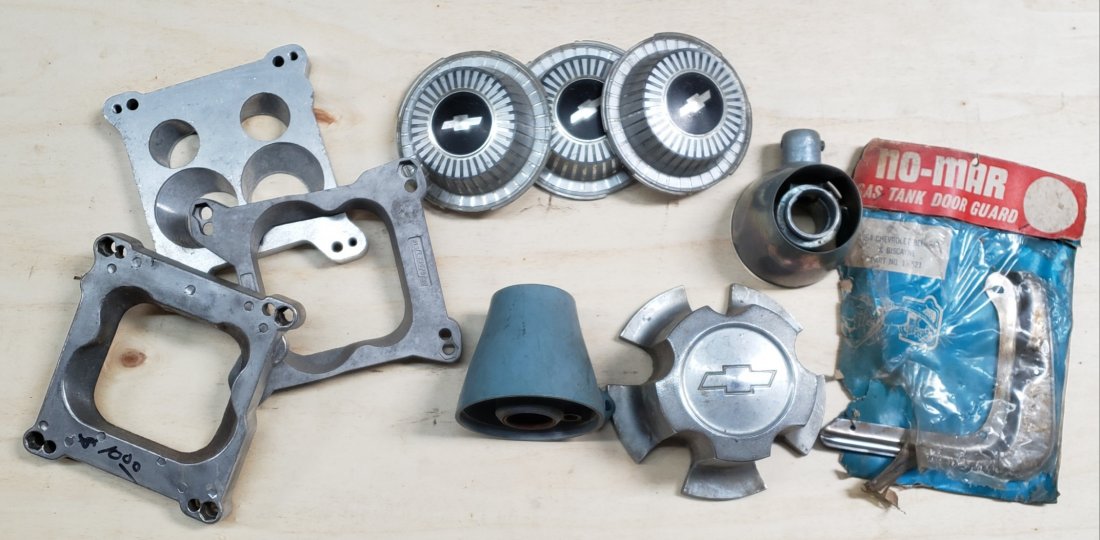 Lot of carb spacers, wheel center caps, steering hubs: Lot of original vintage parts. Please read and understand the terms of this auction prior to placing bids. All bidders are bound to the terms of this auction.