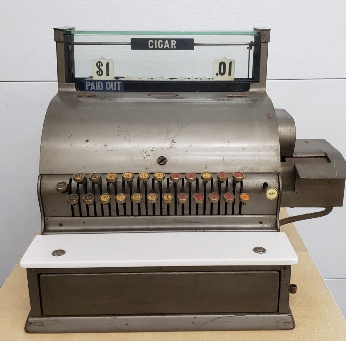 Old Tobacco Store Cash Register: 17" x 16" x 18"h Cash register with the rotating sign to show if the purchase was for Cigars or News. The keys on the register are stuck but the register can be opened by pushing the button under the 