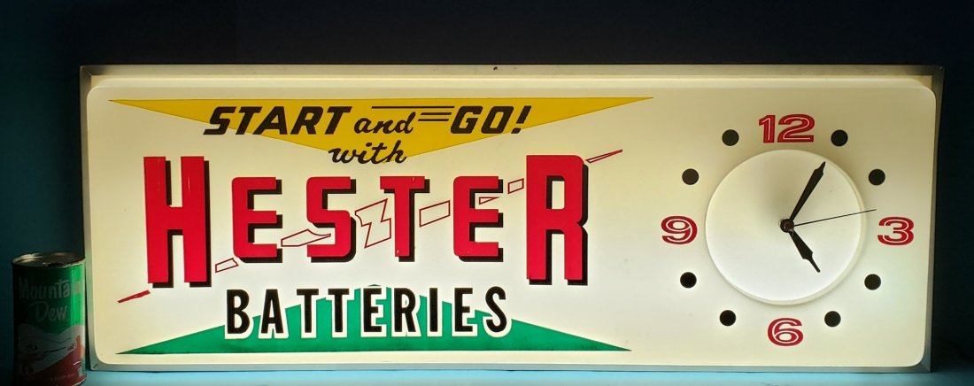 Hester Batteries Automotive Parts Store Clock: 33" x 12" Working electric light up clock with plastic face and aluminum can. In excellent condition with bright colors and minor scuffs. PLEASE NOTE, THERE IS ONLY ONE WAY TO PAY FOR ONLINE ITEMS IN 