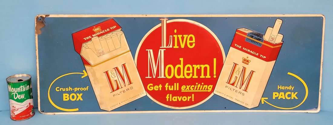 Live Modern L&M Cigarettes embossed sign: 34" x 12" Tin embossed sign with bright colors, scuffs, and toning. PLEASE NOTE, THERE IS ONLY ONE WAY TO PAY FOR ONLINE ITEMS IN THIS AUCTION WHICH IS THROUGH LIVE AUCTIONEERS. THIS IS THE MOST SECUR
