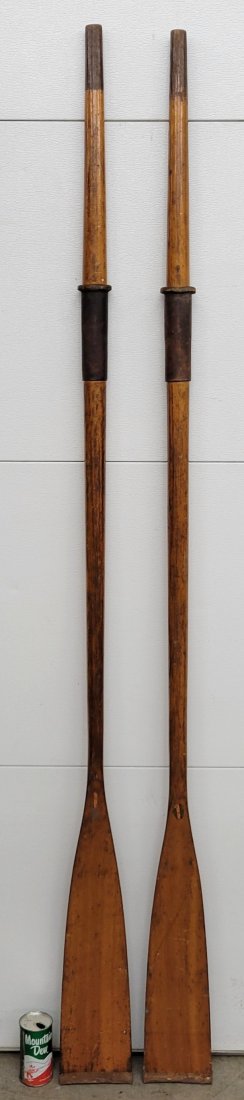 Pair of Old Town Oars: 78" long each. Wood oars with leather handles and copper tips. Oars show normal wear with scuffs, and scratches. Both oars have the original Old Town logo with one logo flaking. * PLEASE NOTE, THERE I