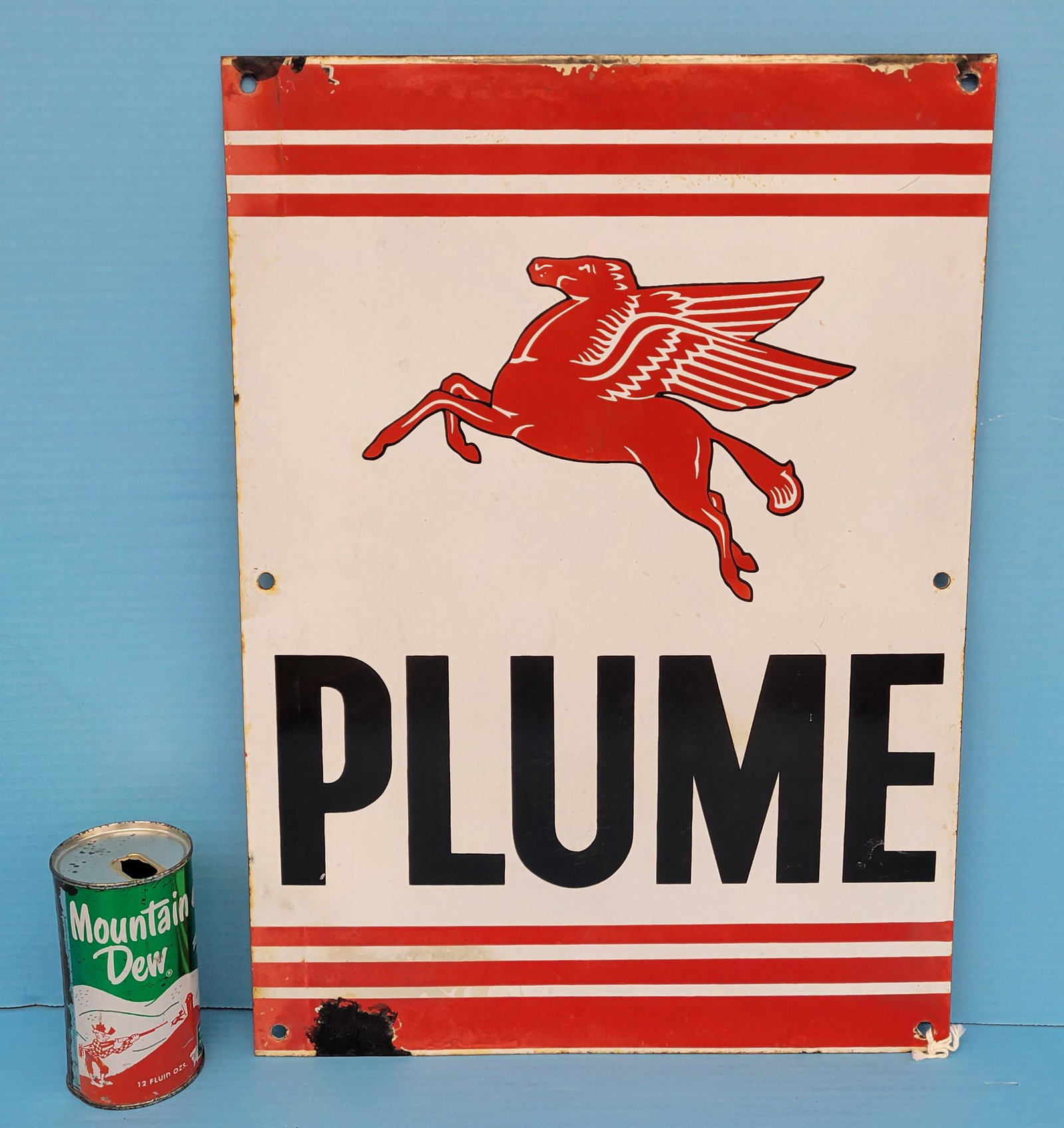 Plume Pegasus Porcelain Sign: Single sided porcelain sign with bright colors, porcelain chip the bottom, light edge wear and light scuffs. The Vacuum Oil Company began operating in Australia in 1895, introducing its Plume brand of