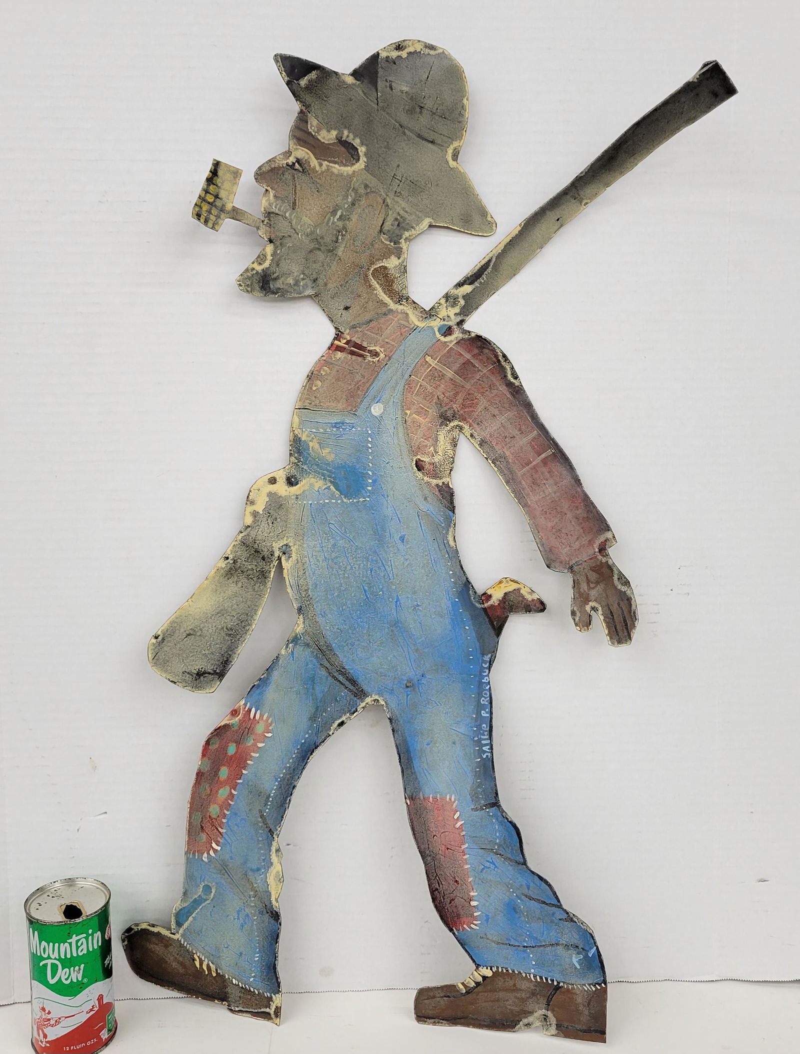Sallie P. Roebuck Painted Metal Folk Art: Painted metal folk art of a hunter in overalls. Painted metal with a clear coat that has toning. Signed by Salle P. Roebuck who was the mother of well known folk artist Richard E. Roebuck. 21" x 32".