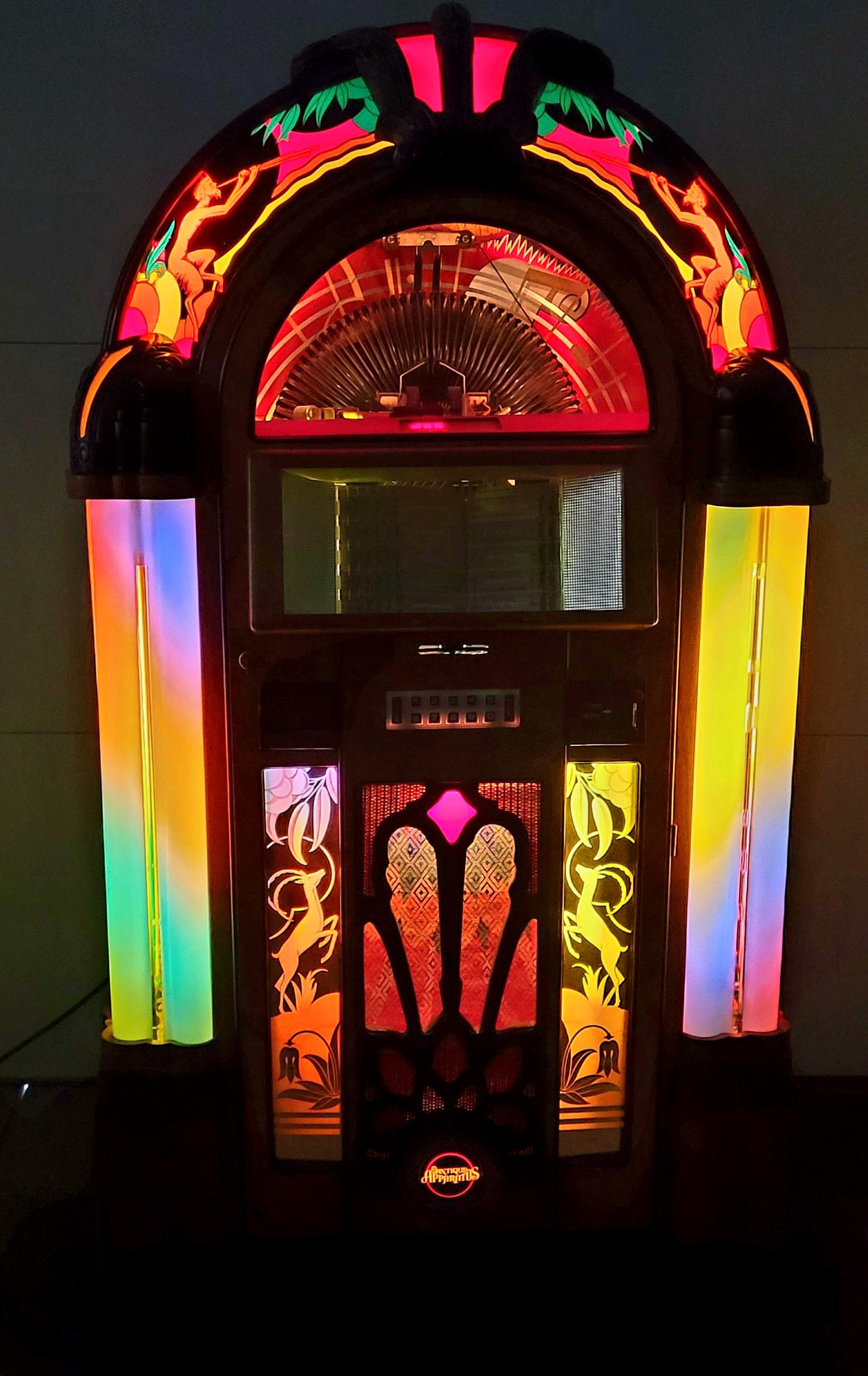 1980's Antique Apparatus Gazelle Bubbler Jukebox: A beautiful 200 select 45 rpm bubbler jukebox. Looks and sounds great. This jukebox is a remake of the Wurlitzer 950. Made by Antique Apparatus this jukebox plays 45 rpm records, bubble tubes work, Th