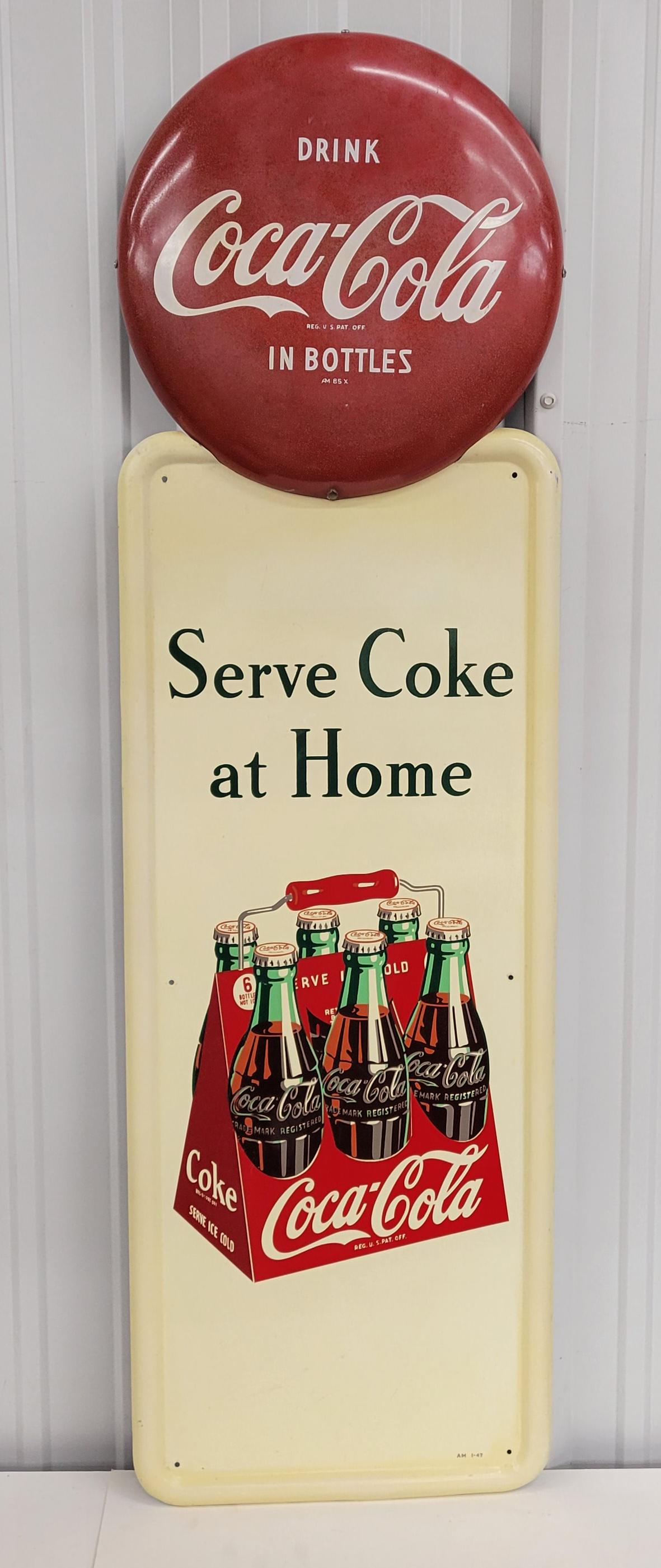 Serve Coke At Home Six Pack Pilaster Sign: Coke. 16" x 54" Single side metal pilaster sign with a 16" Drink Coca Cola In Bottles button attached at the top. The button has fading and hazing throughout the field, minor scratches, and the lower