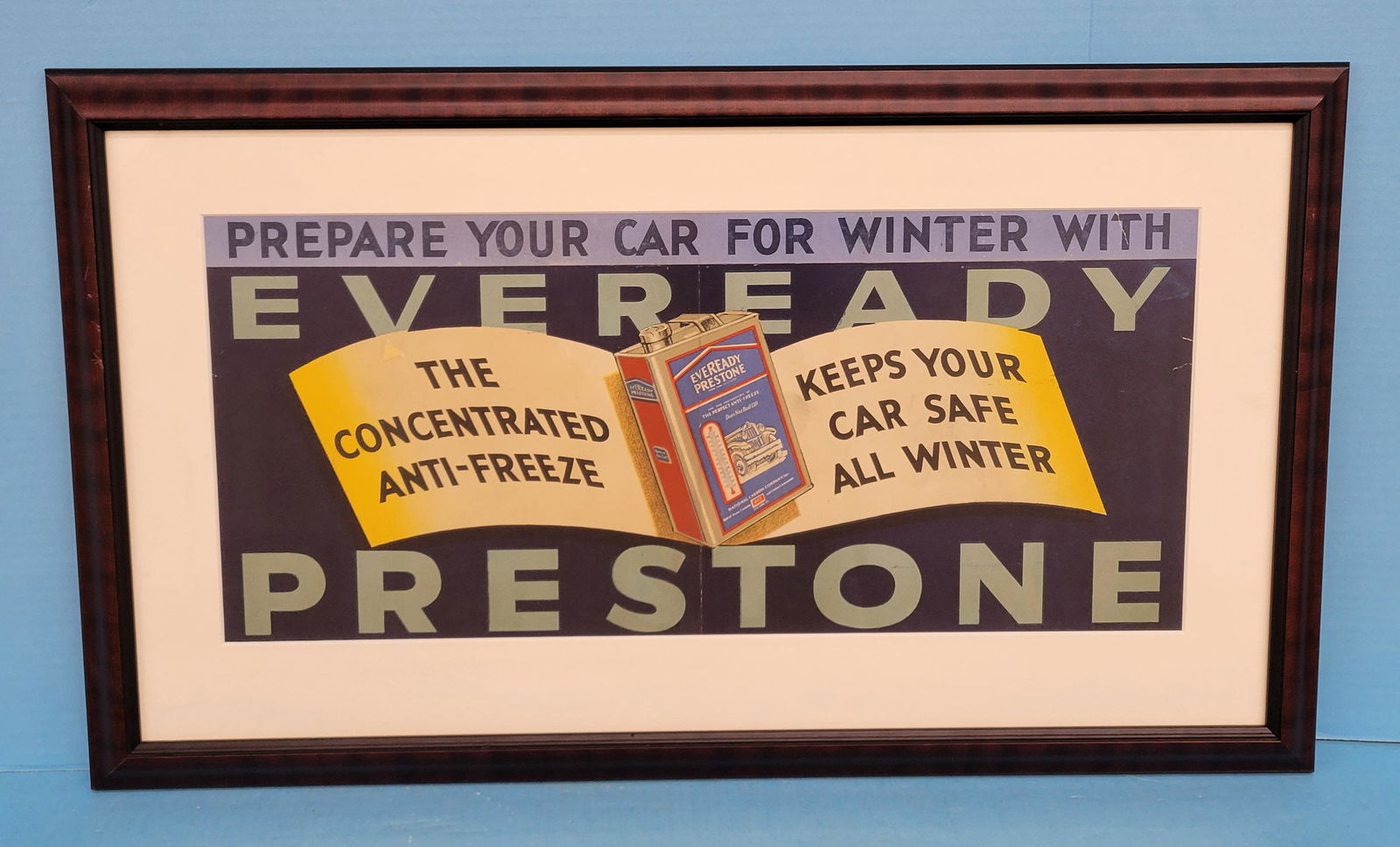 Eveready Prestone Anti Freeze Framed Advertising: 26" x 15.5" Professionally matted and framed under glass paper advertising. Very colorful graphics of the Eveready Prestone Anti Freeze can with car and thermometer. The advertising has small tears ar