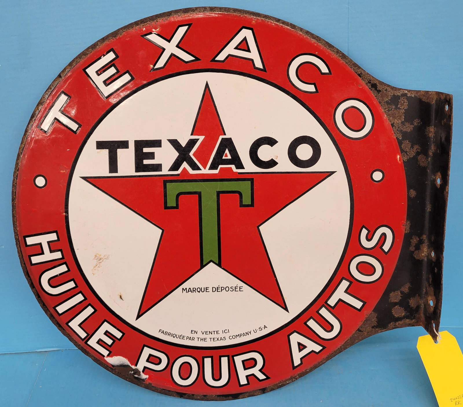 Texaco Huile Pour Autos Porcelain Flange Sign: 24" x 22.5" DSP flange sign with some small areas of porcelain cracking and chipping on both sides. The perimeter has rust with a porcelain chip near the bottom perimeter on both sides. The flange has