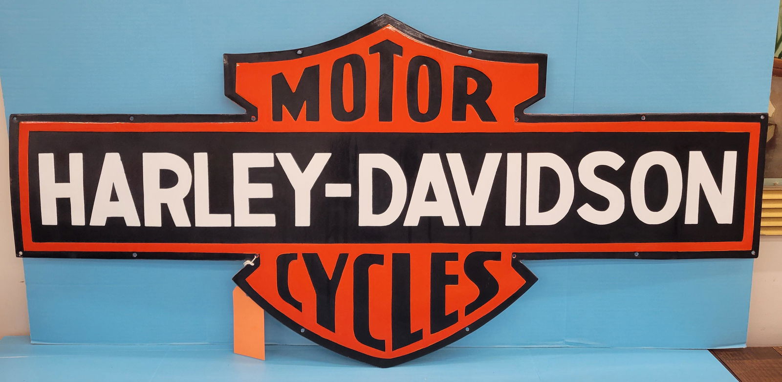 Harley Davidson Single Sided Porcelain Sign: 47.5" x 22.25" SSP sign with excellent color and gloss. Age unknown. PLEASE NOTE, THERE IS ONLY ONE WAY TO PAY FOR ONLINE ITEMS IN THIS AUCTION WHICH IS THROUGH LIVE AUCTIONEERS. THIS IS THE MOST SECU