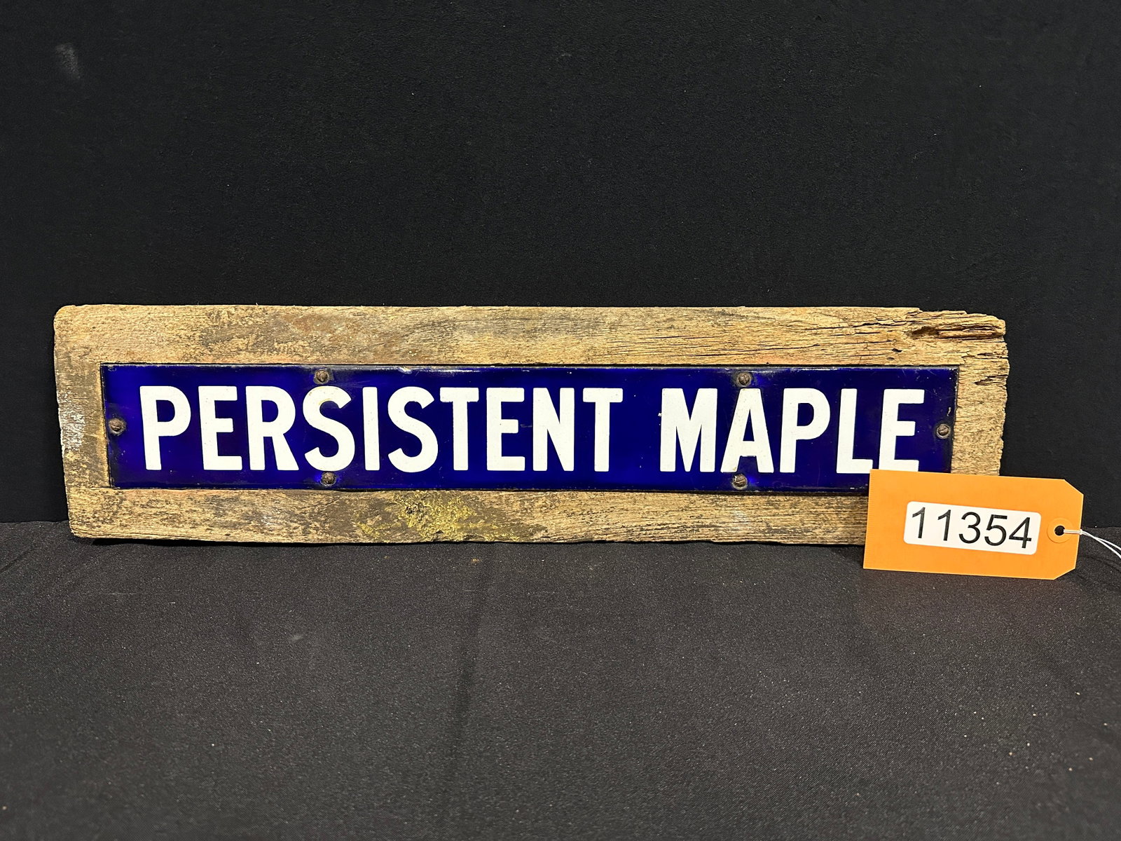 Persistent Maple Porcelain sign mounted on wood: "PERSISTENT MAPLE" porcelain sign mounted on wood. 6" H x 23" W x 1" D.