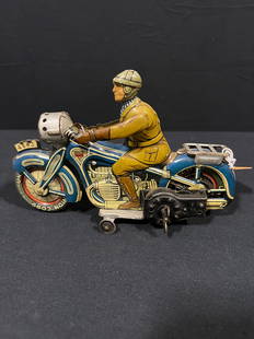 German Tin metal Litho Wind up Arnold Motorcycle Toy: Missing headlight cover. Winding mechanism turns, but doesn?t engage and start rolling.. 10" H x 4" W x 2" D.